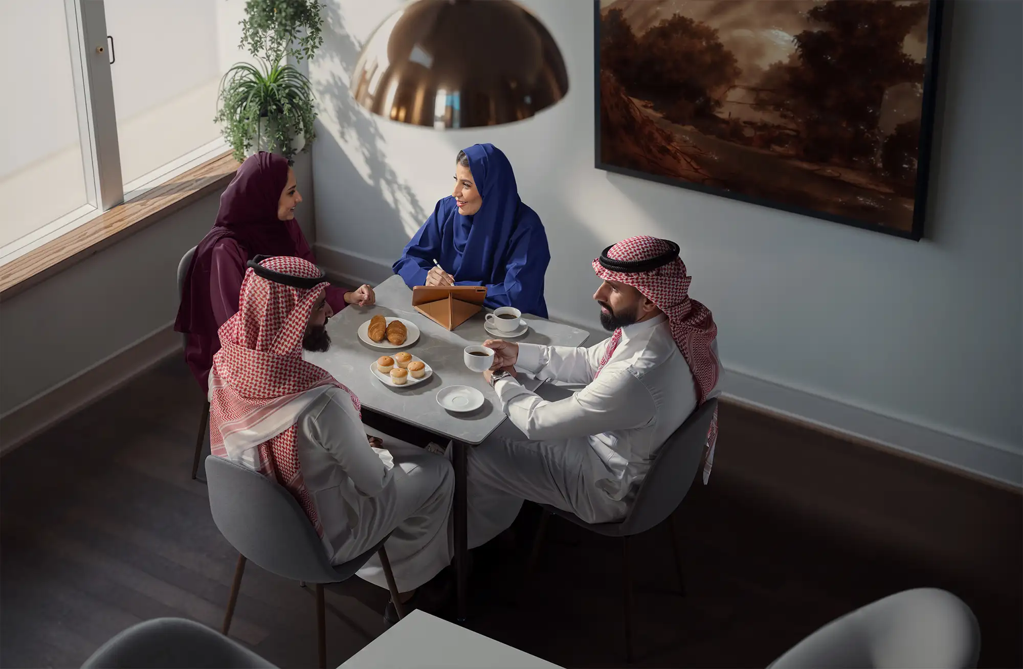 Mobily colleagues collaborating at a meeting table